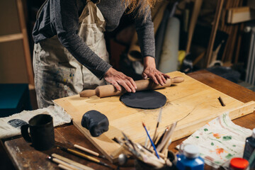 close up of woman sculptor working with clay