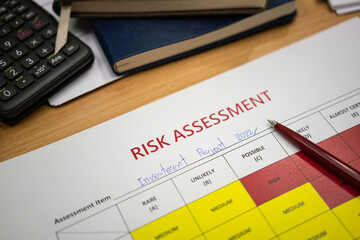 Risk assessment form of investment project 2022 with a luxury ball pen which is placed on paper. Business and financial object photo. Close-up, selective focus.