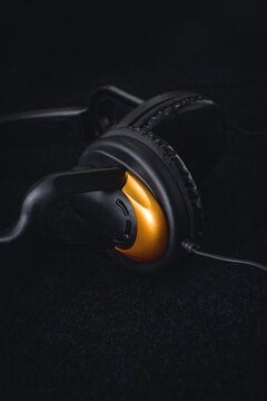 Headphones on a black background with soft light. Place for the inscription