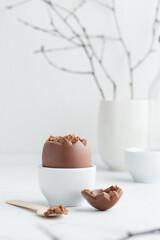 Chocolate easter egg in a white eggholder