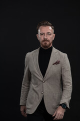 Confident businessman walking forward wearing a causal suit, handsome senior business man hero shot portrait isolated on black