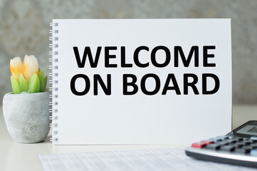 Welcome on board inscription on the notebook on the table, business concept