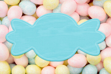 Blank pale blue banner with colorful pastel Easter eggs candy