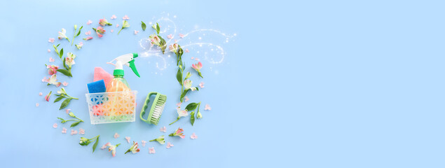 Spring cleaning concept with supplies over pastel blue background. Top view, flat lay