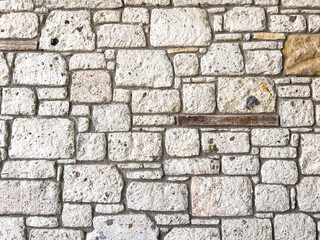 Fototapeta premium Stone wall texture. Part of old rocky hand crafted background with copy space. Walls made of natural bricks. High quality photo. Home and office design backdrop
