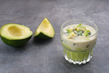 Avocado Milk Cheese Dessert is made from avocado, jelly, cheese, basil seeds, sweetened condensed milk and evaporated milk. Served in a glass. Space for text
