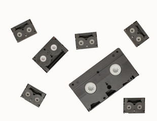 close up flat lay of a selection of audio and video cassettes on a white background