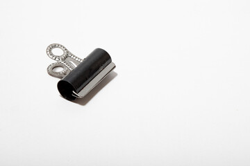 a close up of a single bulldog clip on a white background no people nobody