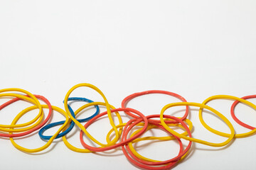 close up macro of multi coloured elastic bands on a white background no people nobody