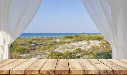 Fototapeta na wymiar Empty wooden table with window in the beach on background 