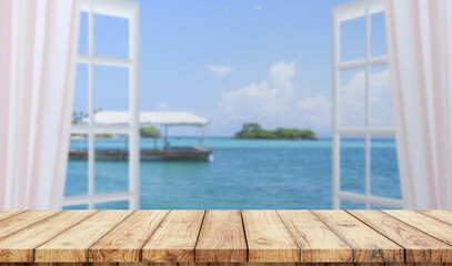 Empty wooden table with window in the beach on background
