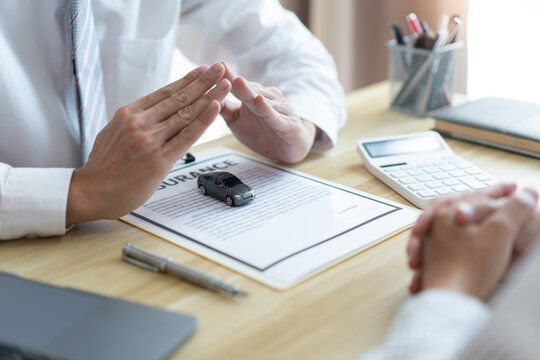 Insurance concept the car merchant presenting the function and condition of the car by using a car model