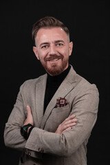 Fototapeta premium Portrait of a stylish elegant senior businessman with a beard and casual business clothes in photo studio isolated on dark background gesturing with hands