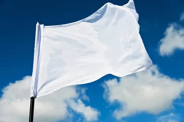 Fotobehang White flag flying against blue sky © xy
