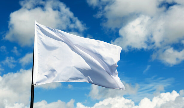 White flag flying against blue sky
