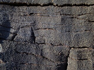 Grayish stone texture with cracks. wallpaper. Horizontal view.
