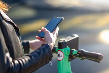 Girl unlocking an electric scooter