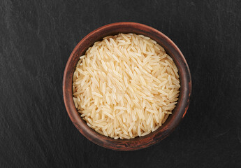 Uncooked dry rice in a bowl top view