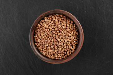 Pile of raw buckwheat grains in a bowl