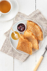 Pancakes with berry jam and honey
