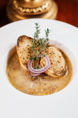 Soup with croutons and onions. Exquisite restaurant menu.