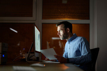 Adult caucasian man working late at the office