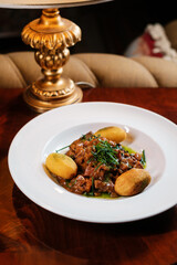 Minced meat with baked potatoes and vegetables. Exquisite restaurant menu.