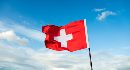 Swiss flag waving against sky