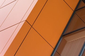 Geometric colored building facade elements with planes, lines and corners with light flare and...