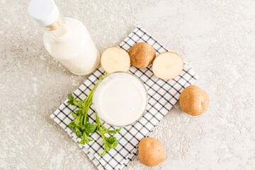 top view of a full glass of potato milk. an alternative to non-milk. vegetable vegan milk. vegetarian food.