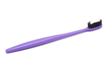purple toothbrush with toothpaste isolated on white background