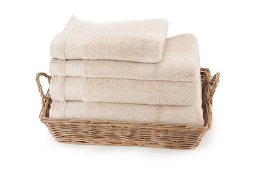 Bath towels in a wicker basket .