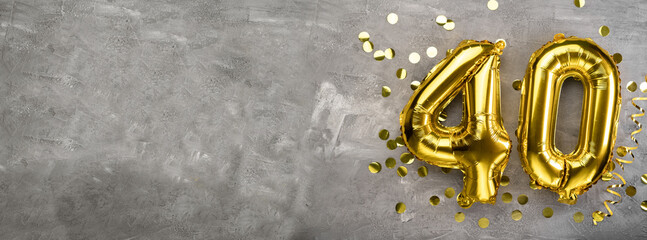 Yellow foil balloon number, number forty concrete background. Greeting card with the inscription...