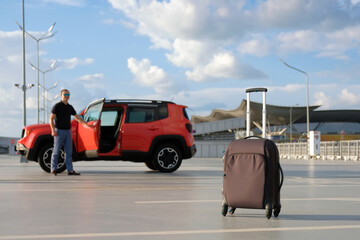 Luggage on the street of the city on the background of the car. Travel concept - 494203992