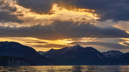 Sea sunset on the background of volcanoes and mountains. Kamchatka, Russia. Sea cruises and travel	
