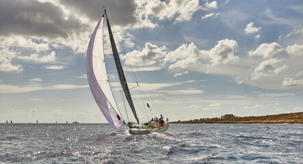 Sailing yachts under sail at the regatta. Yachting race