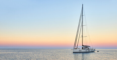 Sailing yacht at sunset in the sea. Travel and yachting - 494204357