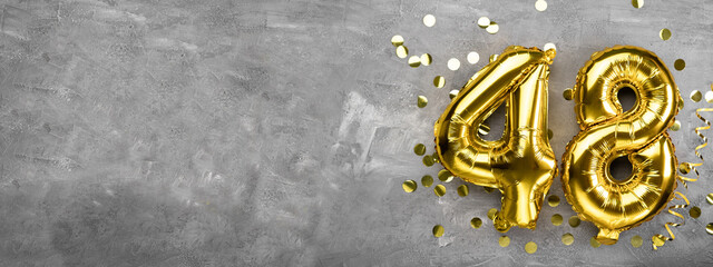 Yellow foil balloon number, number forty eight concrete background. Greeting card with the inscription 48. Anniversary concept. for anniversary, birthday, new year celebration. banner,