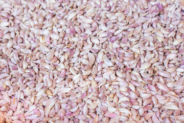 White garlic meat, fresh garlic in the market table. Close-up photo. Vitamins, healthy food, spices. Image of spicy cooking ingredients, pile of white garlic cloves, white garlic cloves,  top view.