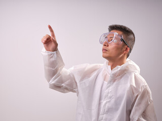 A health care worker wearing a mask and protective clothing on a solid color background