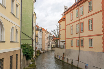 Fototapeta na wymiar Houses of Prague, standing on the canals of the Vltava. Water streets. Corner of the Prague Venice