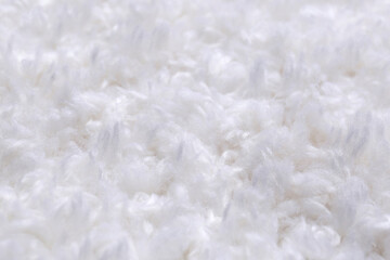 Fototapeta na wymiar Soft white knitted fabric as background, closeup
