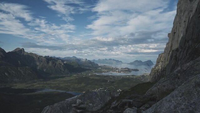 Fluffy clouds over majestic coastal mountain region of Lofoten in Norway. Handheld view