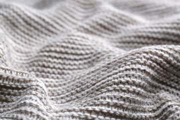 Beautiful grey knitted fabric as background, closeup