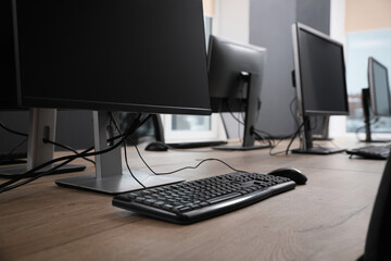 Many modern computers in open space office, closeup view