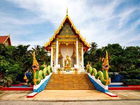 Karon Temple Phuket ,Thailand.The most popular Buddhist temple of tourism on Karon beach in summer day. Entrane to beautiful famous Wat Suwan Khiri Khet temple with dragon Naga. Travel summer trip