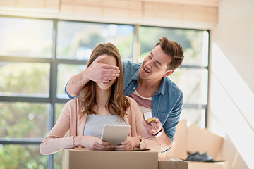 The big surprise. Cropped shot of a young man surprising his girlfriend by proposing while moving house.