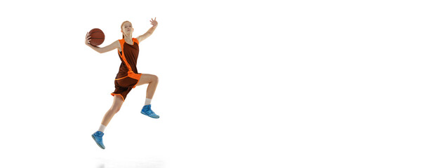 Portrait of professional teen basketball player in motion, training, throwing ball in jump isolated over white studio background. Flyer
