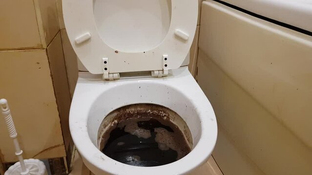 an image of a dirty toilet with a blockage and feces. municipal accident. sewer blockage