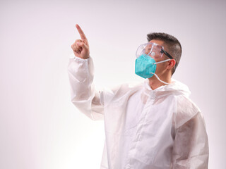 A health care worker wearing a mask and protective clothing on a solid color background